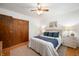 Comfortable bedroom featuring wood floors, white walls, and a beige patterned rug at 6865 Meadow View Dr, Lawrence, IN 46226