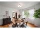 Bright dining area with hardwood floors and a round table set for four at 6865 Meadow View Dr, Lawrence, IN 46226