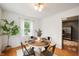 Bright dining area with hardwood floors and a round table set for four at 6865 Meadow View Dr, Lawrence, IN 46226