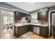 Galley-style kitchen featuring contrasting cabinets and tiled backsplash at 6865 Meadow View Dr, Lawrence, IN 46226
