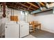 Laundry machines with a table in the basement at 6865 Meadow View Dr, Lawrence, IN 46226