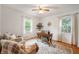 Bright home office featuring hardwood floors, two chairs, a wood desk and natural light at 6865 Meadow View Dr, Lawrence, IN 46226
