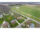 Aerial view of a neighborhood featuring well-manicured lawns, swimming pools, and mature trees at 7018 W Anton Way, New Palestine, IN 46163