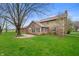 Spacious backyard features a patio area, lush lawn, and mature trees at 7018 W Anton Way, New Palestine, IN 46163