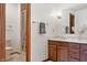 Bathroom with a shower, tiled floors, vanity with granite top, mirror, and warm lighting at 7018 W Anton Way, New Palestine, IN 46163