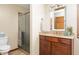 Bathroom features a shower with sliding door, wood vanity, mirror, and neutral color palette at 7018 W Anton Way, New Palestine, IN 46163