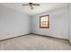 Empty bedroom with neutral carpet, window, and ceiling fan at 7018 W Anton Way, New Palestine, IN 46163