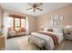 Neutral primary bedroom features a window seat, bed, bench, and modern decor at 7018 W Anton Way, New Palestine, IN 46163