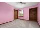 Charming bedroom with pink walls, carpeted floor, closet, and a window for natural light at 7018 W Anton Way, New Palestine, IN 46163