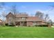 Charming two-story brick home with a spacious front yard and mature trees at 7018 W Anton Way, New Palestine, IN 46163