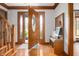 Bright foyer with hardwood floors, coat rack and bench with easy access to the front door at 7018 W Anton Way, New Palestine, IN 46163