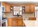 Well-lit kitchen featuring wooden cabinetry, stainless steel appliances, and granite countertops at 7018 W Anton Way, New Palestine, IN 46163