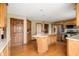 Spacious kitchen with wood cabinets, stainless steel appliances, and a granite countertop island at 7018 W Anton Way, New Palestine, IN 46163