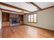 Bright living room featuring exposed wood beams, fireplace, and built-in shelves at 7018 W Anton Way, New Palestine, IN 46163