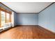 Bright living room with hardwood floors and a cozy window seat with decorative pillows at 7018 W Anton Way, New Palestine, IN 46163