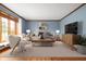 Bright living room featuring hardwood floors, modern furnishings and a cozy window seat at 7018 W Anton Way, New Palestine, IN 46163
