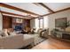 Inviting living room with wood beams, fireplace, and built-in shelves offers a cozy and stylish gathering space at 7018 W Anton Way, New Palestine, IN 46163