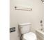 Bright bathroom with a toilet, towel rack, and white tiled shower and wall at 8690 Jaffa Ct W Dr # 18, Indianapolis, IN 46260