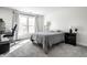 Bright bedroom featuring neutral walls, carpet, and a large window at 8690 Jaffa Ct W Dr # 18, Indianapolis, IN 46260