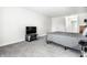 Bedroom featuring a cozy bed with a gray comforter, TV, and neutral walls at 8690 Jaffa Ct W Dr # 18, Indianapolis, IN 46260