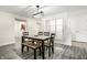 A modern dining room with a wooden table, bench, and sleek light fixture at 8690 Jaffa Ct W Dr # 18, Indianapolis, IN 46260