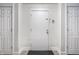 A bright hallway with neutral walls features three white doors at 8690 Jaffa Ct W Dr # 18, Indianapolis, IN 46260