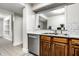 Kitchen with stainless steel dishwasher and double sink with view into another room at 8690 Jaffa Ct W Dr # 18, Indianapolis, IN 46260