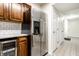 Kitchen featuring stainless steel refrigerator and wood cabinets with modern white subway backsplash at 8690 Jaffa Ct W Dr # 18, Indianapolis, IN 46260