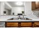Modern kitchen sink with stainless steel fixtures, white countertops, and updated backsplash at 8690 Jaffa Ct W Dr # 18, Indianapolis, IN 46260