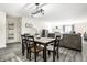 An open-concept living room with a dining area and fireplace offers cozy living at 8690 Jaffa Ct W Dr # 18, Indianapolis, IN 46260