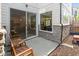 Back patio with wooden chairs and sliding door leading to the house at 9208 Hawley Dr, Indianapolis, IN 46216