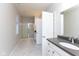 Bright bathroom boasts a glass shower, gray countertops, and white cabinets with a tiled floor at 9208 Hawley Dr, Indianapolis, IN 46216