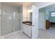 Bathroom with glass-enclosed shower, vanity, and an open door looking into the bedroom at 9208 Hawley Dr, Indianapolis, IN 46216