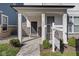 Inviting front porch with stone accents and meticulous landscaping, showcasing a welcoming entrance at 9208 Hawley Dr, Indianapolis, IN 46216
