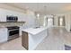 Kitchen with stainless steel appliances and large center island flows into a living area at 9208 Hawley Dr, Indianapolis, IN 46216