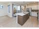 Modern kitchen with island and stainless steel appliances, seamlessly blending with the living space and backyard access at 9208 Hawley Dr, Indianapolis, IN 46216