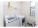 Laundry room features a front-load washing machine and dryer with wire shelving at 9208 Hawley Dr, Indianapolis, IN 46216