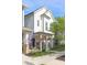 Attractive townhome showcasing a charming front porch, well-maintained landscaping, and inviting curb appeal at 9208 Hawley Dr, Indianapolis, IN 46216