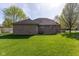 Brick home's rear exterior featuring well-maintained lawn and mature trees, offering a serene view at 11 Stratford Way, Danville, IN 46122