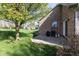 Patio and grill area with a spacious lawn and a brick exterior wall at 11 Stratford Way, Danville, IN 46122