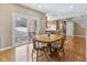 Cozy dining area with hardwood floors, a wooden table, and sliding glass doors to the outside at 11 Stratford Way, Danville, IN 46122