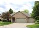Charming single story brick home with an attached two car garage and beautifully maintained lawn at 11 Stratford Way, Danville, IN 46122