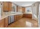 Spacious kitchen featuring wood cabinets, lots of counter space, and hardwood floors at 11 Stratford Way, Danville, IN 46122