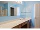 Bright blue bathroom features a large mirror, double sink vanity with wood cabinets and a shower/tub combo at 11130 Sanabria Dr, Indianapolis, IN 46235