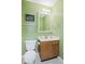 Standard bathroom featuring green walls, a well-lit vanity, and a toilet, providing essential amenities at 11130 Sanabria Dr, Indianapolis, IN 46235