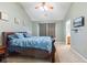 Vaulted ceilings accent the main bedroom featuring a wood sleigh bed, ceiling fan, carpet floors and ensuite bath access at 11130 Sanabria Dr, Indianapolis, IN 46235