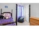 Cozy bedroom with a dark wood bed frame, bean bag chair, and purple curtains, offering a comfortable space at 11130 Sanabria Dr, Indianapolis, IN 46235
