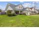 Charming home featuring a two-car garage, front porch, and well-maintained lawn at 11130 Sanabria Dr, Indianapolis, IN 46235
