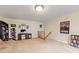 Bright living area with a desk, futon, and multiple bookshelves, creating a versatile space at 11130 Sanabria Dr, Indianapolis, IN 46235