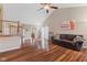 Spacious living room with hardwood floors, sofa, and a view into the kitchen at 11130 Sanabria Dr, Indianapolis, IN 46235